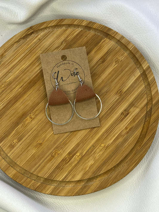 Medium metal hoops with brown leather accent earrings. Metal is plain